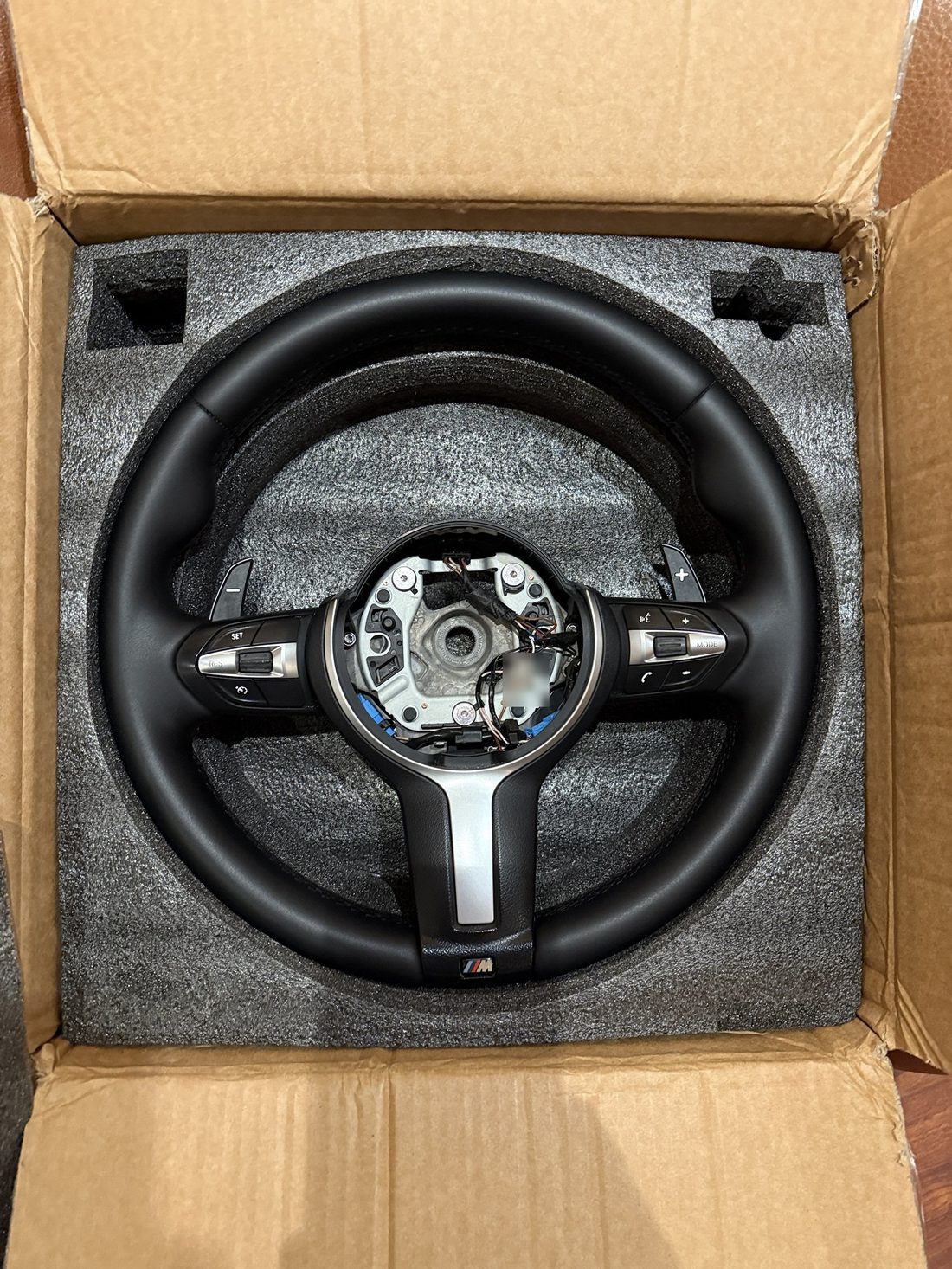Restored BMW M Sport steering wheel in the same box, matte black leather